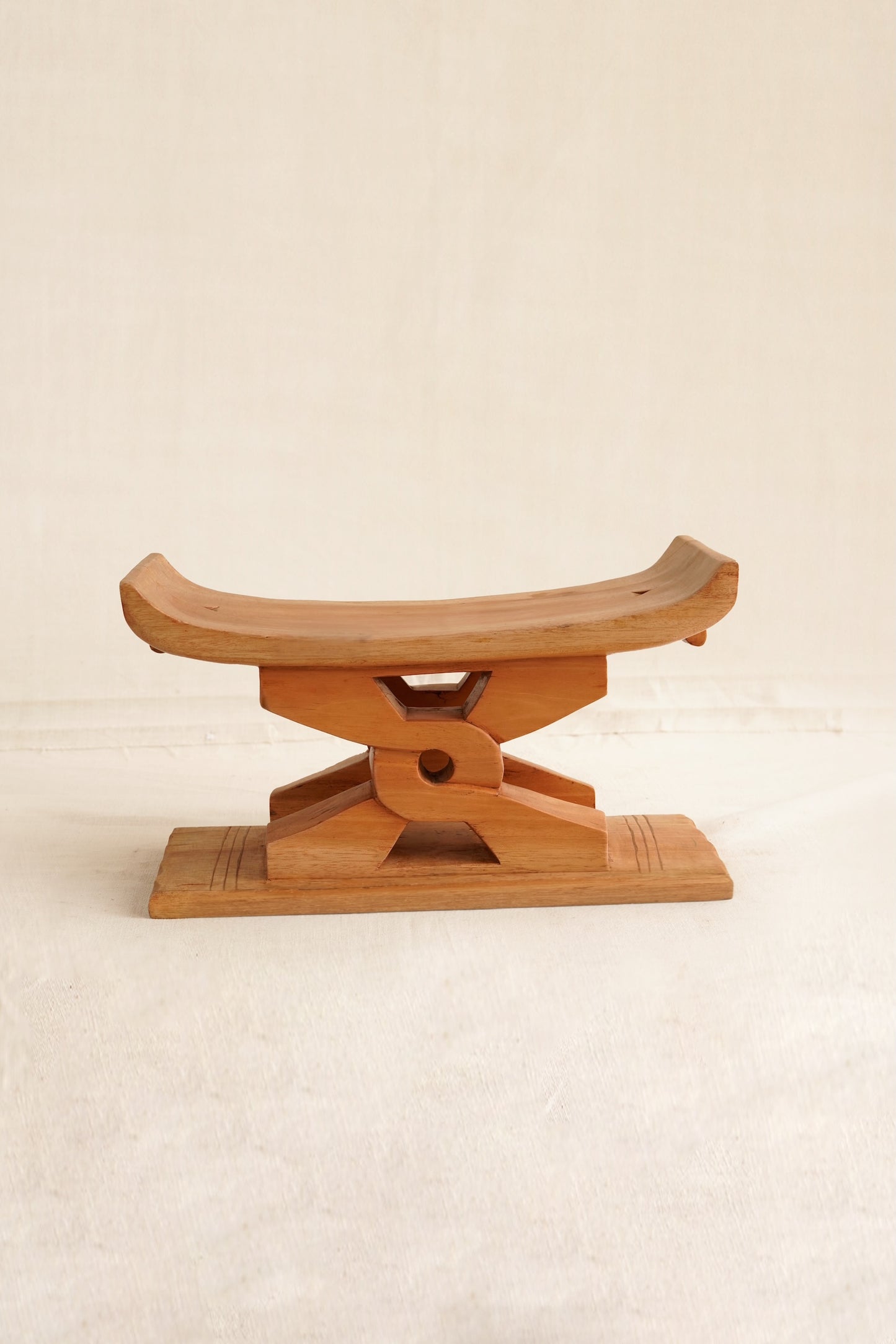 Miniature neutral polished Ashanti stool with Nyansapo Adinkra symbol handmade in Ghana