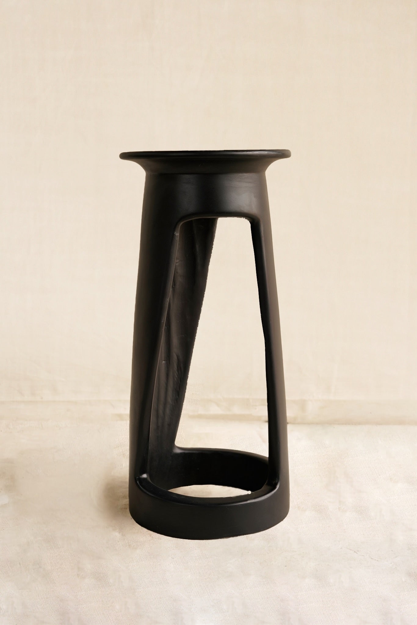 Black stool on a beige background