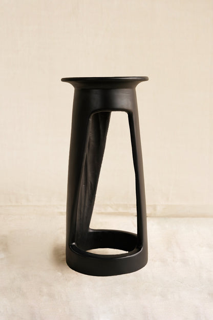 Black stool on a beige background